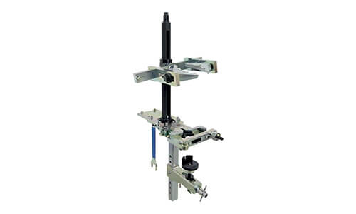 Stationary spring compressor